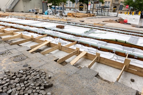 Preview: New tram rails laying on european city street. Installation modern railway tramway rails for trams