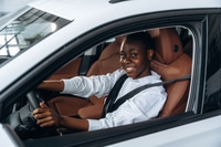 Preview: In white shirt. Woman is in the modern car