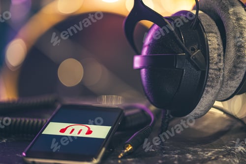 Preview: Musical background with a phone and headphones on a dark background.