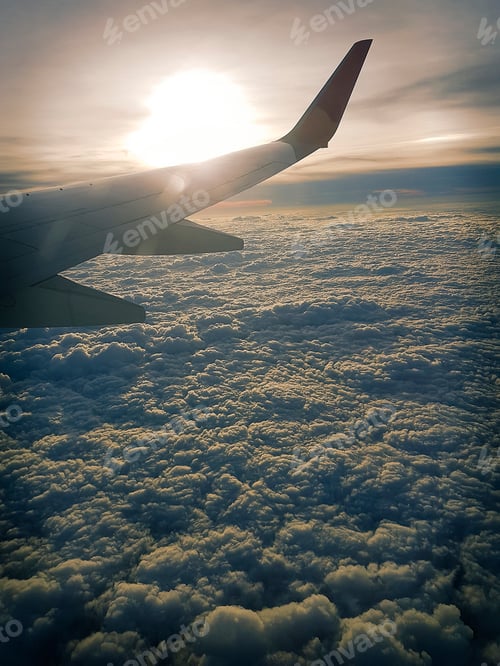 Preview: Airplane flying over the clouds