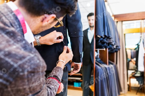 Preview: Tailor helping customer in clothing store
