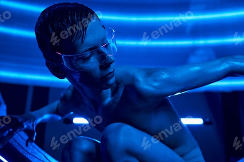 Preview: unearthly humanoid creature in goggles sitting in high-tech innovative device in discovery center
