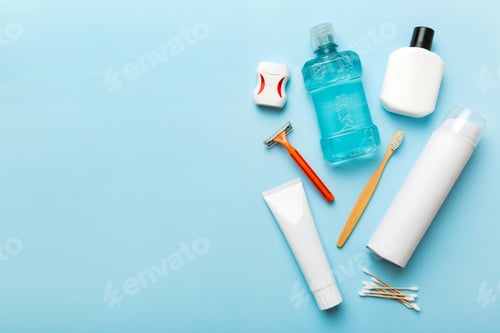 Preview: Composition with bath cosmetics on table. razor, toothpaste, soap, gel, toothbrush, mouthwash