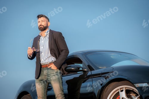 Preview: Handsome elegant male next to his sports car