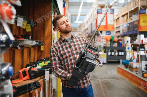 Preview: Worke holds electric saw in tool store