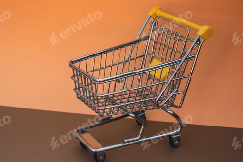 Preview: Empty shopping trolley cart on beige background. Copy space for your text. Online shopping, buy mall