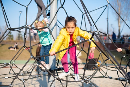 Preview: Two little girls playing on the rope playground at the outdoors park.