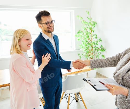 Preview: young couple shaking hands deal contract real estate investment business agreement agent handshake