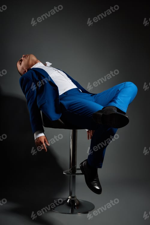 Preview: Contrast portrait of a man businessman in an expensive business suit on a dark
