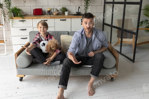 Preview: Boy and Man Relaxing on Sofa with Dog