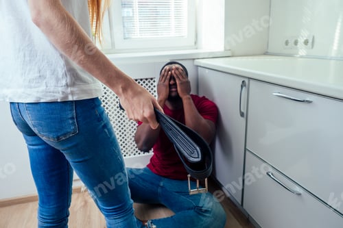 Preview: domestic violence. angry girl hitting african american man at kitchen