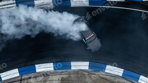 Preview: Aerial top view high speed car drifting on asphalt race track with lots of smoke.