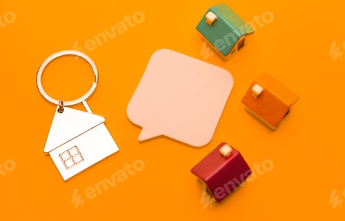 Preview: Keychain and toy houses on orange background