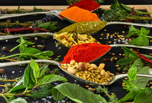Preview: Colourful various herbs and spices for cooking on dark background.