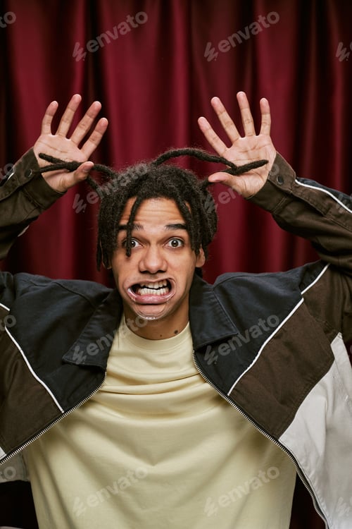 Preview: Portrait of Young Adult Black Man Making Silly Face in Photo Booth