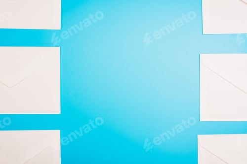 Preview: Blue background with white paper envelopes with empty space in the center.