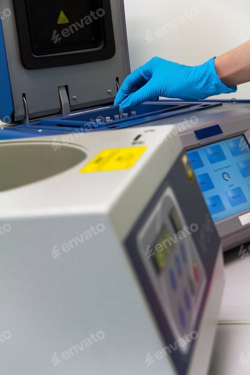 Preview: Research scientist putting test tube into real-time pcr machine