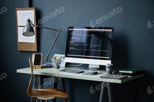 Preview: Modern Workspace Featuring Computer Monitor Displaying Programming Code