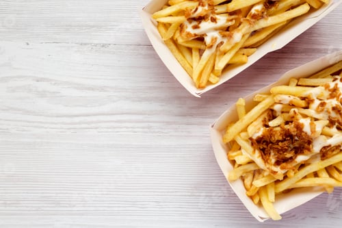Preview: French fries with cheese sauce and fried onion in paper boxes