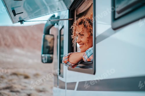 Preview: One female tourist enjoy view and freedom feeling inside a camper van vehicle looking outside