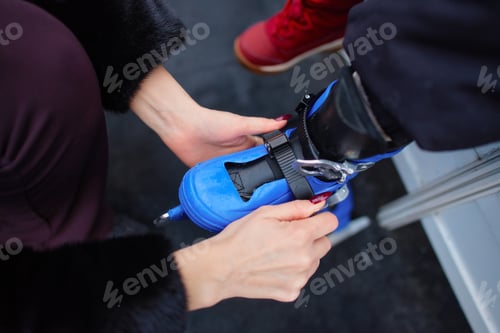 Preview: Preparing roller skates for a fun outdoor activity at a park in autumn