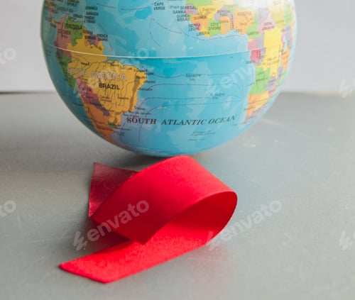 Preview: World AIDS day 1 December, close-up of world globe with red ribbon