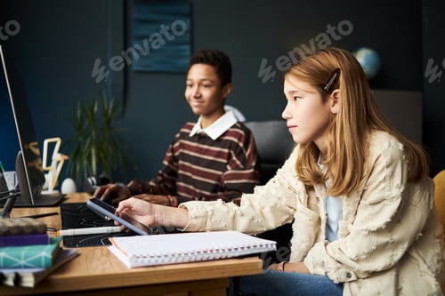 Preview: Teenage Caucasian Girl and Black Boy Using Computers in Classroom Setting