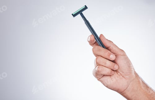 Preview: Grooming, shaving and hand with a razor for body hair, hygiene and clean shave on a studio backgrou