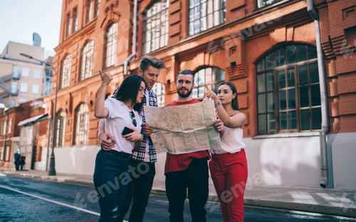 Preview: Calm adult lost travelers with paper map asking for advice locals on street in city