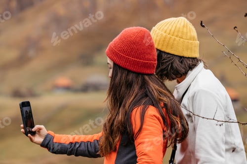 Preview: Women taking selfies while hiking in the countryside.