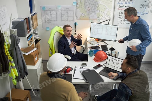 Preview: Caucasian Foreman Leading Multiethnic Team Planning Construction Project
