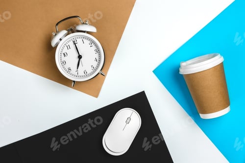 Preview: Paper cup, computer mouse and alarm clock on colored paper background.