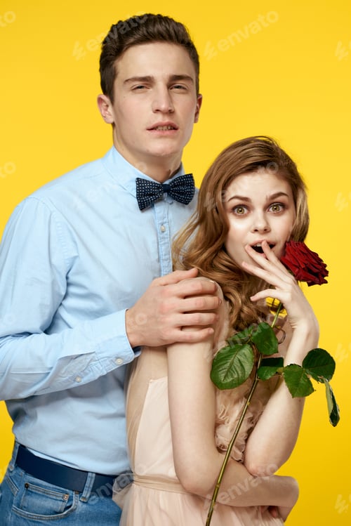 Preview: romantic couple in love with red flower hugging each other cropped view Copy Space