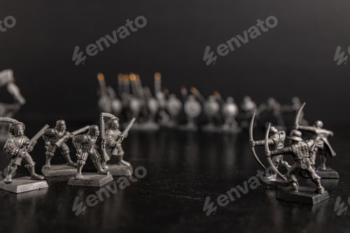 Preview: Grayscale selective focus shot of soldier with guns and bows figurines