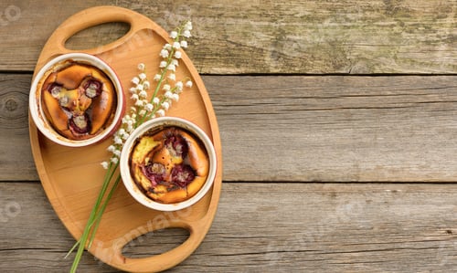Preview: Cottage cheese dessert baked in portioned round ceramic plates on a wooden table, top view