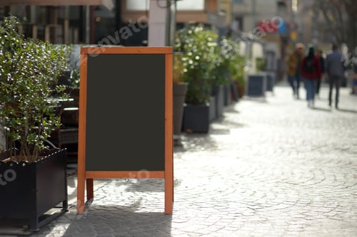 Preview: An empty menu board near a stylish outdoor cafe in a European city on the background of urban street