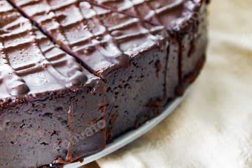 Preview: Chocolate cake cut into several pieces with decoration