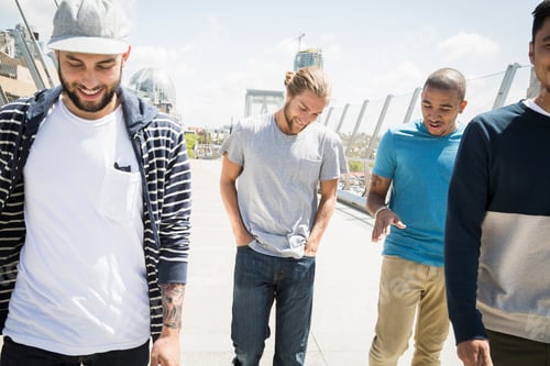 Preview: Group of young men walking along a bridge.