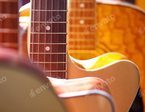 Preview: Guitars hanging in a music store in early afternoon sunlight