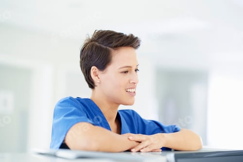 Preview: Female nurse leaning on nurses station in hospital