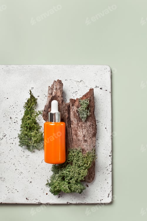 Preview: Organic cosmetics and natural beauty: face serum with moss and wood on green, top view flatlay