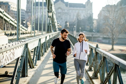 Preview: Young couple running in urban enviroment