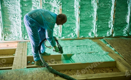 Preview: Worker spraying polyurethane foam for insulating wooden frame house.