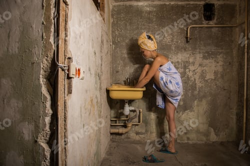 Preview: Cheap Accommodation. The Girl Washing Her Feet In The Sink