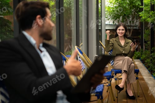 Preview: Both of businessperson using digital tablet at outdoor cafe. Business people meeting in coffee shop.