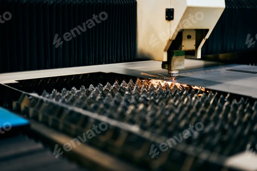 Preview: Industrial Laser Cutting Machine with Sparks in a Factory Setting