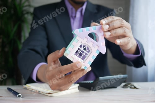 Preview: the concept of finance concept , man holding house in hand