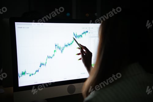 Preview: Young Asian broker international stock traders working at night in office using computer