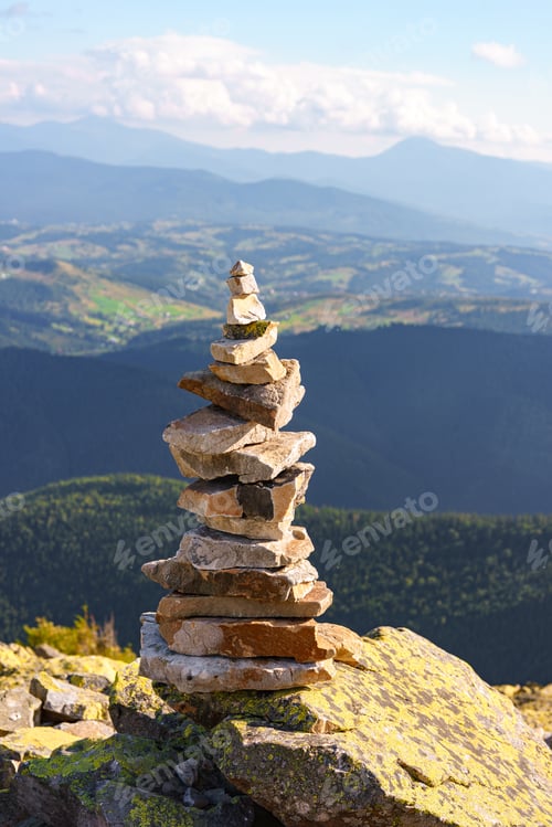Preview: Stacked Rock Cairn On Mountain Peak With Carpathian View Background. Travel And Hiking Exploration