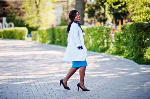 Preview: Smiling Woman Doctor Walks on Cobblestone Street